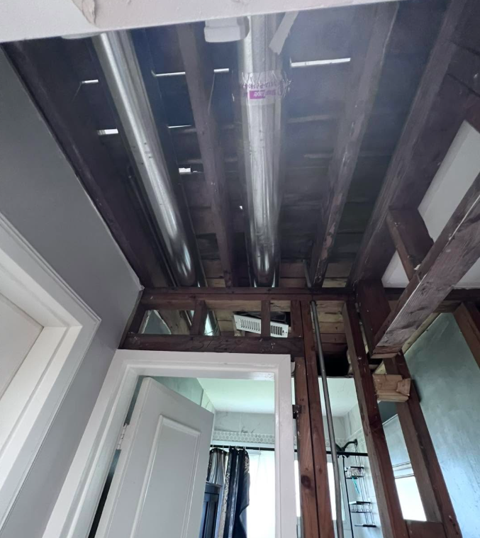 Ceiling removed to joists and ductwork after water traveled from an upper floor